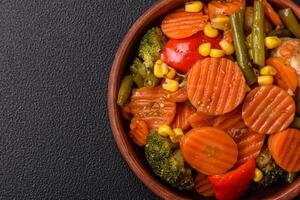 Delicious healthy vegetables steamed carrots, broccoli, asparagus beans and peppers photo