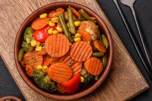 Delicious healthy vegetables steamed carrots, broccoli, asparagus beans and peppers photo