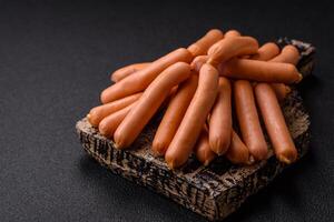 Delicious fresh small vegetarian sausages with salt, spices and herbs photo