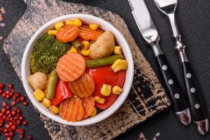 Delicious healthy vegetables steamed carrots, broccoli, asparagus beans and peppers photo