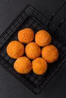 Delicious  balls of mozzarella and parmesan cheese with salt and spices photo