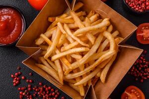 Delicious crispy golden fries with salt and spices photo