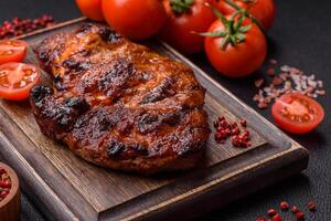 Fresh juicy delicious beef steak on a dark background photo