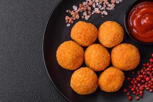 Delicious  balls of mozzarella and parmesan cheese with salt and spices photo