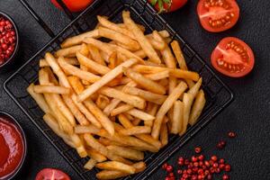 Delicious crispy golden fries with salt and spices photo