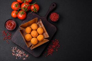 Delicious  balls of mozzarella and parmesan cheese with salt and spices photo