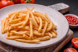 Delicious crispy golden fries with salt and spices photo