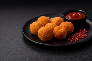 Delicious  balls of mozzarella and parmesan cheese with salt and spices photo