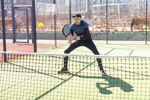 hombre jugando paleta tenis a adentro tono foto