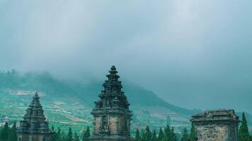 Misty landscape with ancient temple towers and lush greenery. video