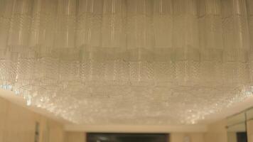 Textured glass ceiling panel with warm ambient lighting in a modern interior setting. video