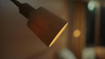 Close-up of a modern lamp against a blurred background, with a warm and cozy ambiance. video