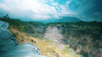 Scenic view of a lush valley with rocky foreground under a cloudy sky. video