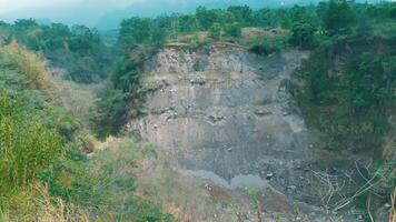 Grassy hillside with exposed rocky soil and sparse vegetation, depicting erosion or natural terrain. video