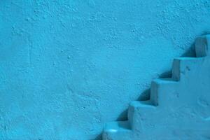 Blue concrete wall and stairs. Abstract interior summer background photo