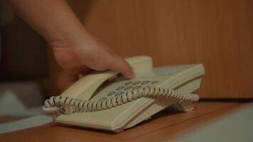 Vintage telephone on a wooden desk with a blurred background. video