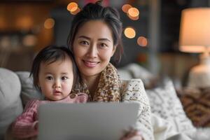 AI generated Asian woman sitting, holding baby in her arms, using laptop. She seems to be busy studying or having fun while taking care of her child photo