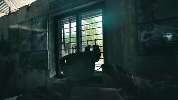 Abandoned building interior with a vintage bathtub in a dilapidated room with peeling walls and a barred window. video