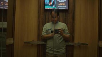 Man taking a selfie in mirror with warm ambient lighting video