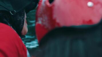 Close-up of a person in a red helmet and scarf, with a blurred background suggesting motion or travel. video