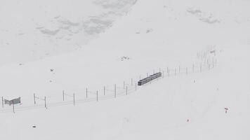 Zermatt, Switzerland - The train of Gonergratbahn running to the Gornergrat station in the famous touristic place with clear view to Matterhorn during a heavy snow storm. video