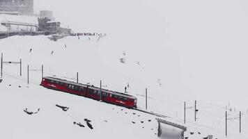 Zermatt, Switzerland - The train of Gonergratbahn running to the Gornergrat station in the famous touristic place with clear view to Matterhorn during a heavy snow storm. video