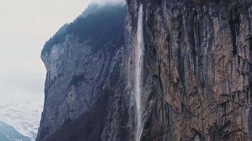 Beautiful aerial view of the Staubbach Falls in Switzerland. Magical panoramic aerial view of Switzerland during cloudy weather. video