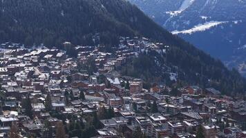 Aerial panoramic view of the Verbier ski resort town in Switzerland. Classic wooden chalet houses standing in front of the mountains. video