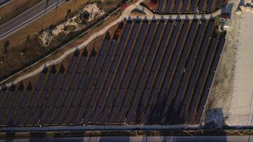 Solar panel rows and highway aerial view. Photovoltaic panels farm. Dominican video