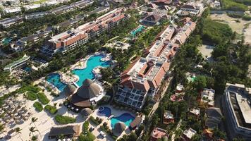 Aerial view of tropical resort with swimming pool area, family fun in vacation, Punta Cana in Dominican Republic, all inclusive travel and leisure. Sunset. Top view. Secrets Royal Beach. video