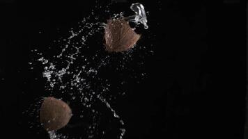 Man's hands throw up coconut cut in half video