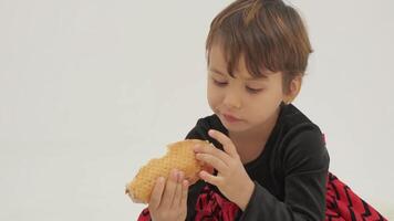 Short haired little girl eats hot dog video