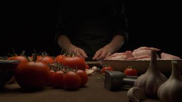 the chef prepares the whole chicken for frying on the table with vegetables video