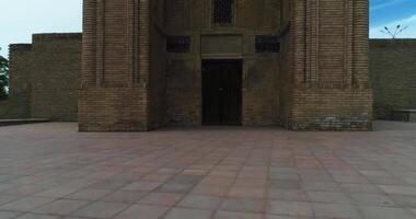 The drone flies near the main gate of the Magok-i-Attari Mosque complex in old Bukhara, Uzbekistan. Cloudy day. video