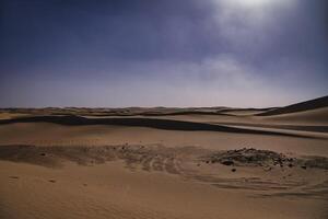 A panoramic sand dune of sahara desert at Mhamid el Ghizlane in Morocco wide shot photo