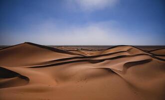 A sand dune of sahara desert at Mhamid el Ghizlane in Morocco photo