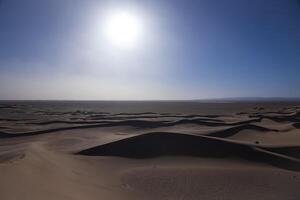 A panoramic sand dune of sahara desert at Mhamid el Ghizlane in Morocco wide shot photo