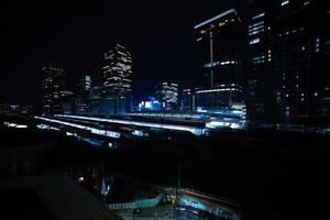 A night panoramic cityscape in front of Tokyo station wide shot photo