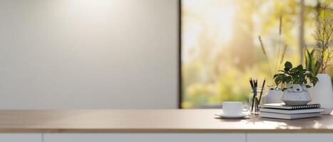 A wooden tabletop with decor and space for display products against the white wall and window. photo