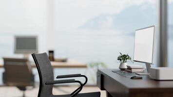 A computer desk in a modern bright office with an amazing large window with a beautiful nature view. photo