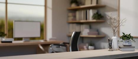 A close-up image of a table with decor in a modern minimalist home office with a computer desk. photo