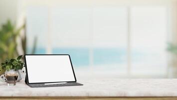 A luxurious white marble table with a white-screen digital tablet mockup in a modern beach house. photo