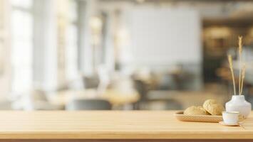 A space on a wooden tabletop with a blurred background of a contemporary coffee shop. photo