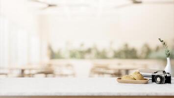 A white table features a display space with a blurred background of a contemporary cafe. photo