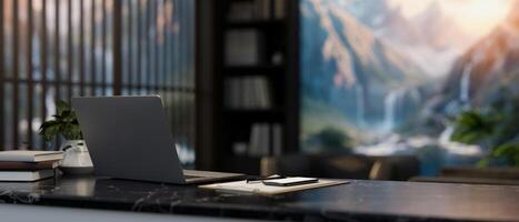 A back view image of a laptop and report on a black marble desk in a contemporary private office. photo