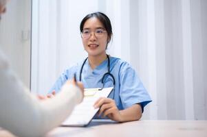 A doctor explaining a medical insurance claim document to a patient during a meeting in the office. photo