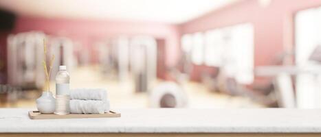 A presentation space on a white tabletop features towels and a bottle of water in a modern fitness. photo