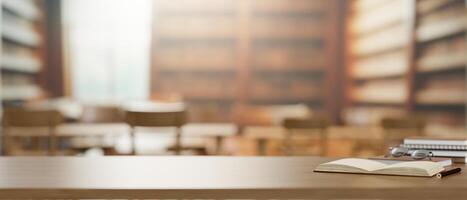 A wooden table features books, eyeglasses, and a presentation space in a library. photo