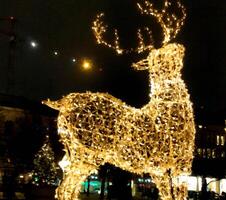 A glowing reindeer at night on the street in Scandinavia in digital painting style photo