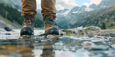 Hiking hiker traveler landscape adventure nature outdoors sport background panorama - Close up of feets with hiking shoes from a man or woman walking in the river photo